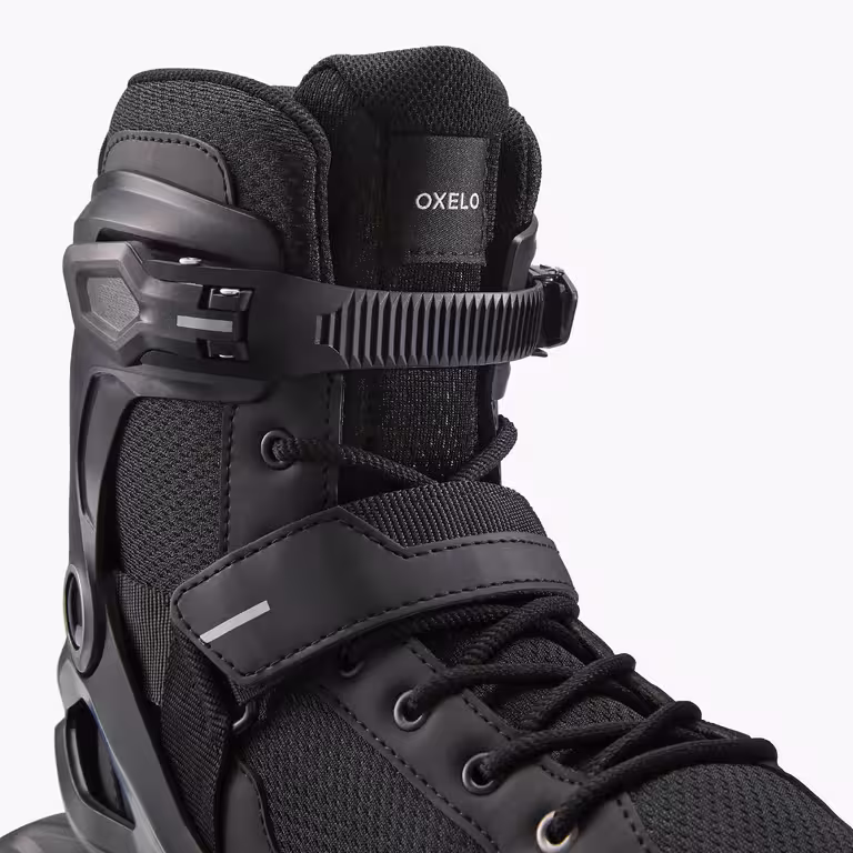 A close up shot of the top of an all black OXELO inline skate